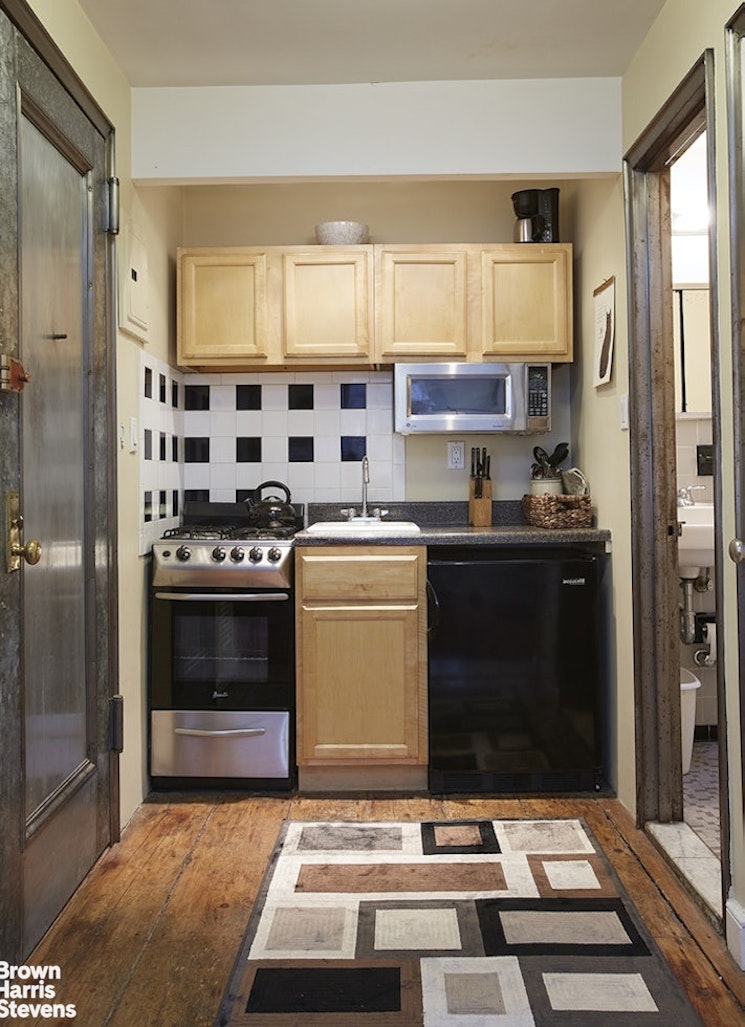 428 West 44th Street Manhattan, NY 10036 - Photo 17 of 17 a view of kitchen with sink stove and refrigerator