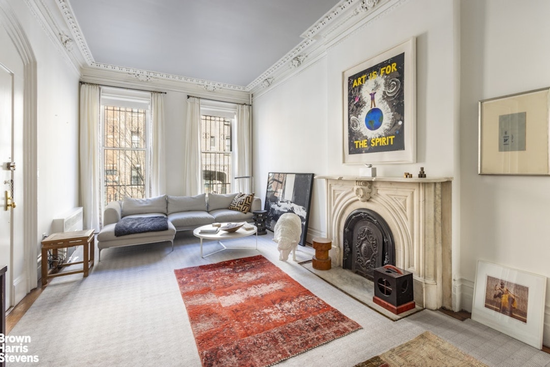 428 West 44th Street Manhattan, NY 10036 - Photo 5 of 17 a living room with furniture and a fireplace