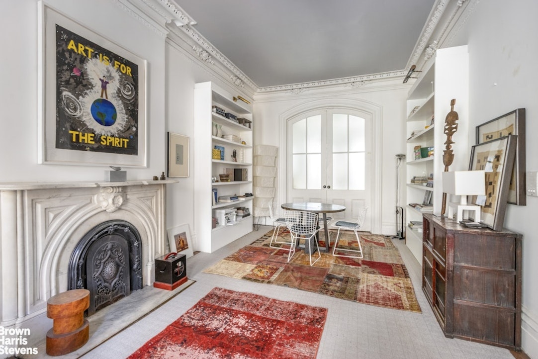 428 West 44th Street Manhattan, NY 10036 - Photo 6 of 17 a living room with fireplace furniture and a rug