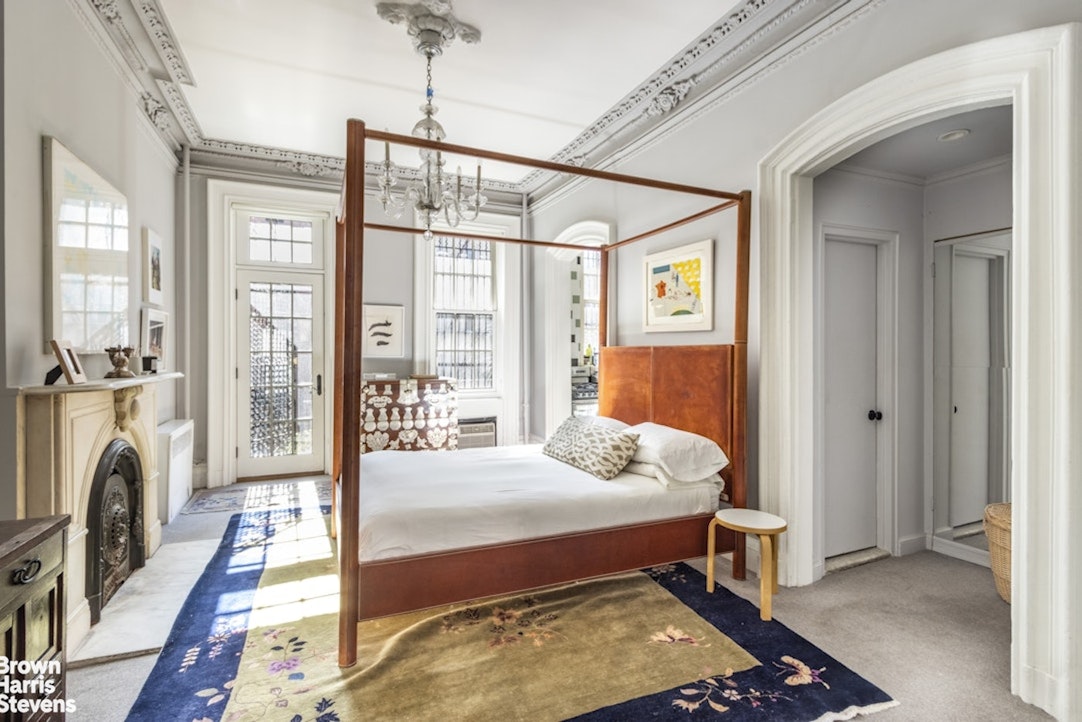 428 West 44th Street Manhattan, NY 10036 - Photo 7 of 17 a bedroom with furniture and a fireplace