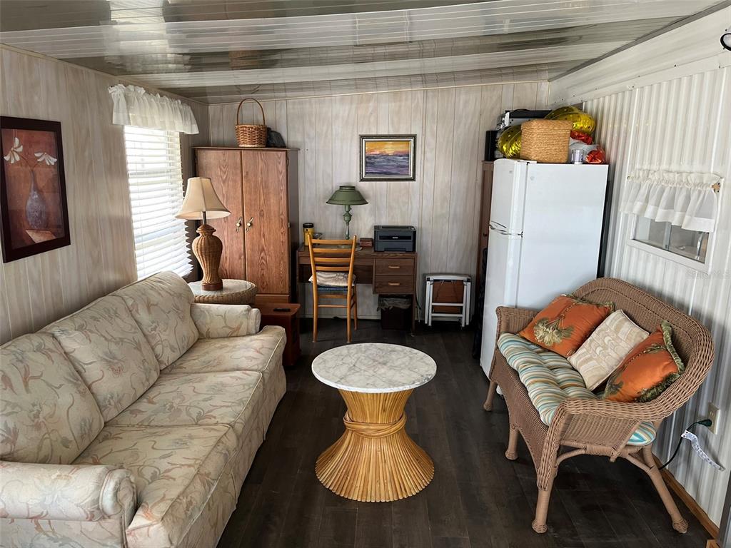 1040 Main Street, Unit 192 Dunedin, FL 34698 - Photo 5 of 15 a living room with furniture and a wooden floor