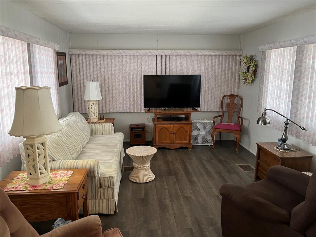 1040 Main Street, Unit 192 Dunedin, FL 34698 - Photo 7 of 15 a living room with furniture and a flat screen tv