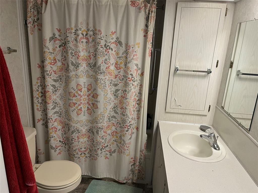 1040 Main Street, Unit 192 Dunedin, FL 34698 - Photo 8 of 15 a bathroom with a sink toilet and shower