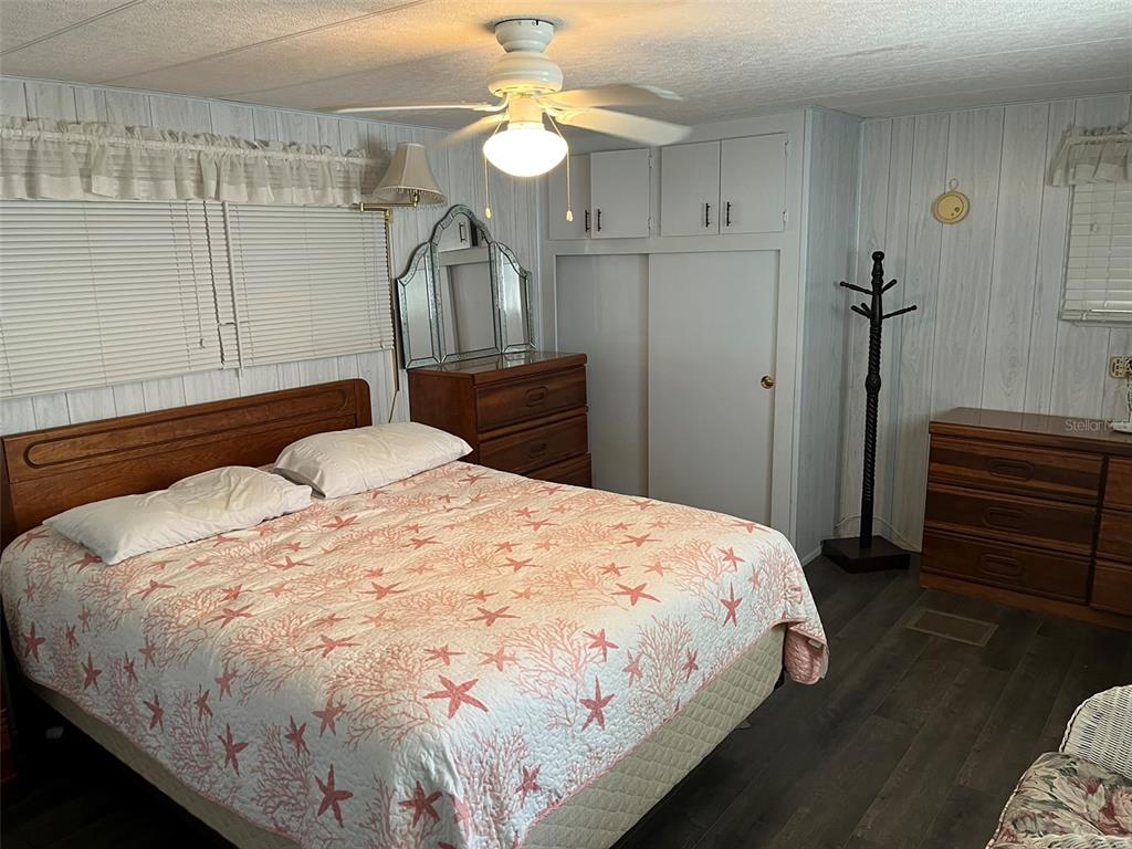 1040 Main Street, Unit 192 Dunedin, FL 34698 - Photo 9 of 15 a bedroom with a bed and a chandelier