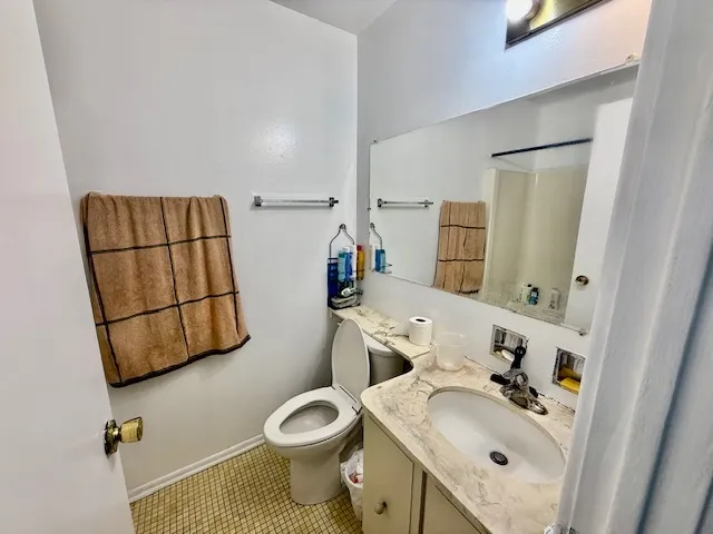 a bathroom with a sink toilet and mirror