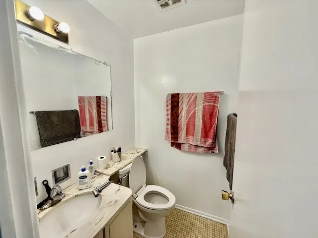 a bathroom with a sink mirror and toilet