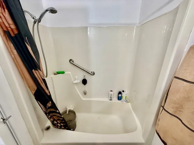 a bathroom with a sink a bathtub and a window