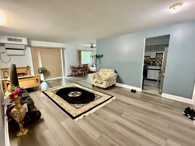 a living room with furniture and wooden floor