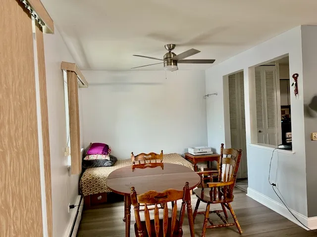 a view of a dining room with furniture and wooden floor