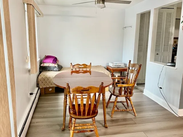 a view of a dining room with furniture and wooden floor