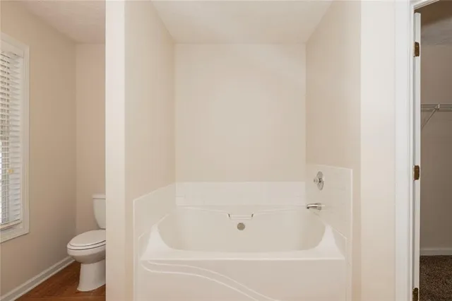a white bath tub sitting next to a white toilet