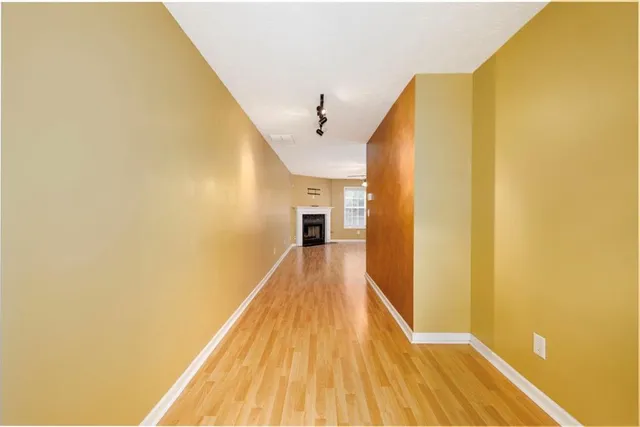 a view of a room with wooden floor