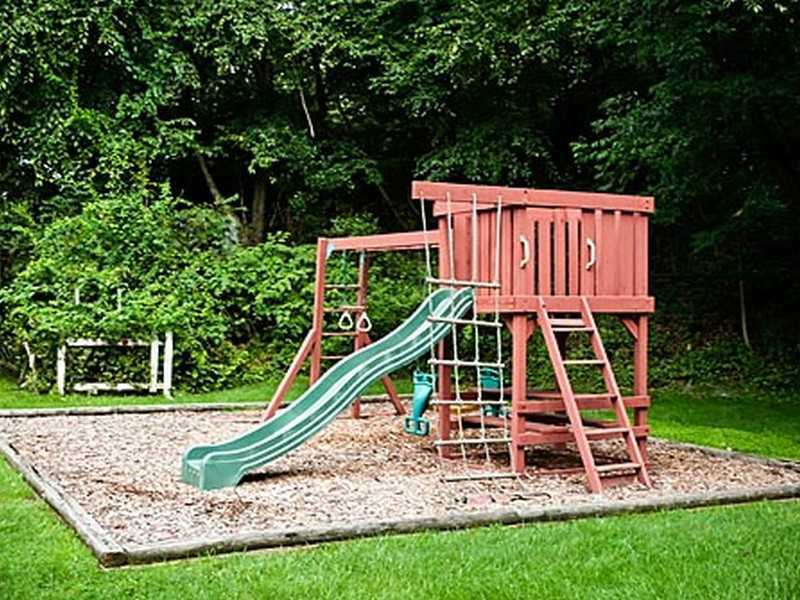 57 Stirrup Lane, Unit 57 Riverside, CT 06878 - Photo 13 of 17 a view of a house with a yard swing and slide