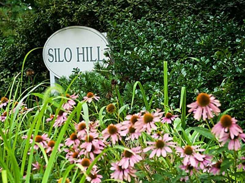 57 Stirrup Lane, Unit 57 Riverside, CT 06878 - Photo 3 of 17 a view of a sign in a garden