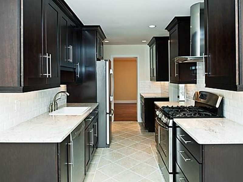 57 Stirrup Lane, Unit 57 Riverside, CT 06878 - Photo 7 of 17 a kitchen with stainless steel appliances granite countertop a sink stove refrigerator and cabinets