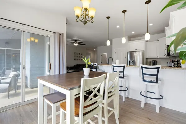 a very nice looking dining room with a large window and wooden floor