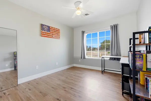 an empty room with wooden floor and closet