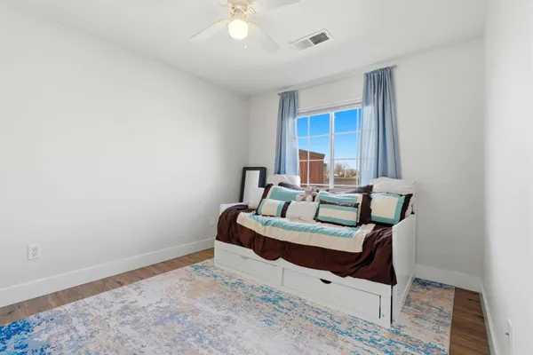 a bathroom with a granite countertop sink a toilet and a mirror