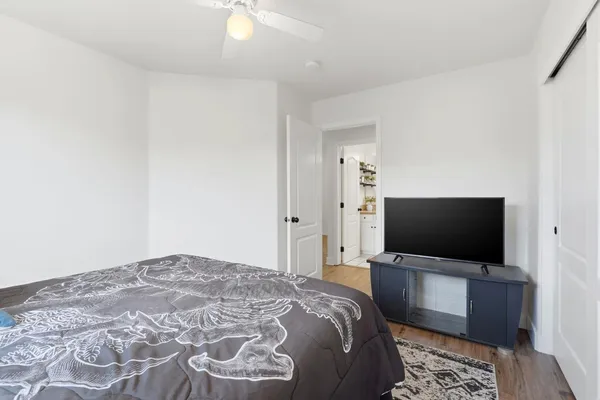 a bedroom with a bed and a chandelier