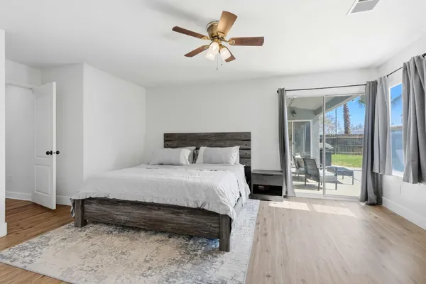 a bedroom with a bed and a ceiling fan