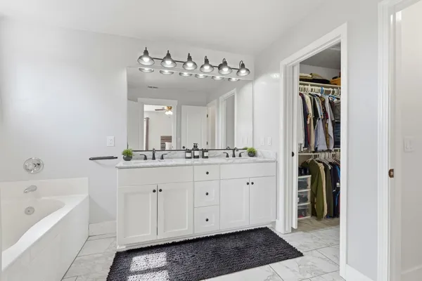 a bathroom with a double vanity sink a shower and a mirror