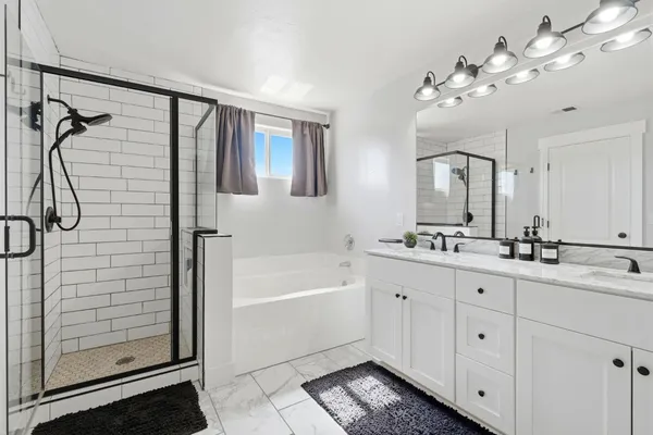 a bathroom with a double vanity sink and a mirror