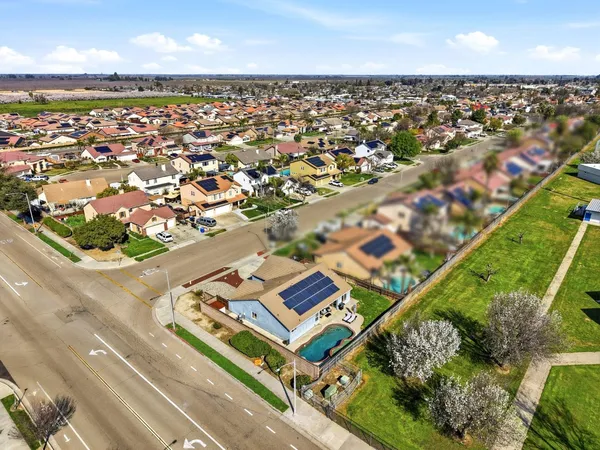 an aerial view of residential houses with outdoor space
