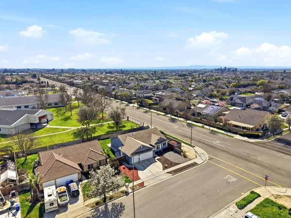 an aerial view of a swimming pool and outdoor seating