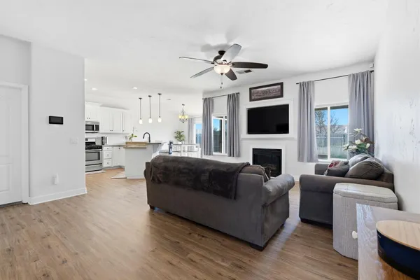 a living room with furniture and kitchen view
