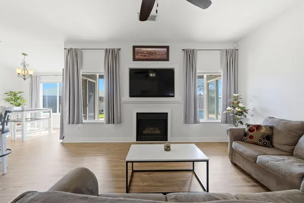 a living room with furniture a fireplace and a flat screen tv
