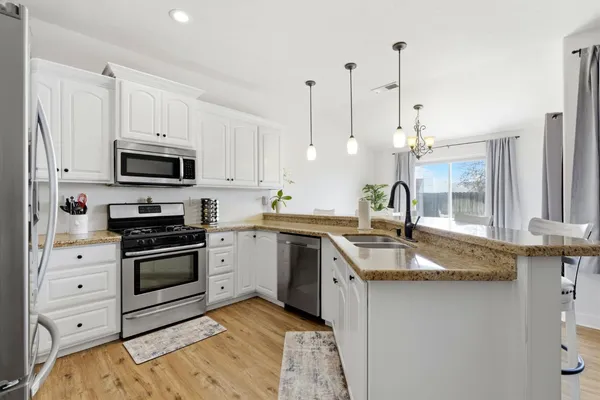 a kitchen with sink stove and cabinets