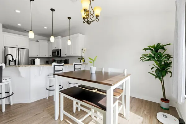 a view of a dining room with furniture and wooden floor
