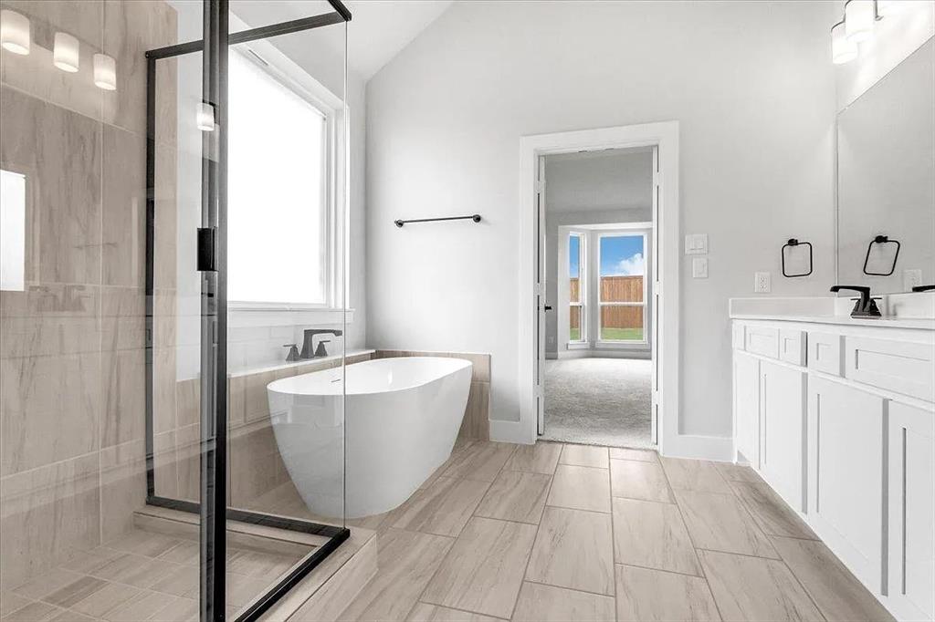6246 Shasta Creek Road Celina, TX 75009 - Photo 15 of 24 a bathroom with a bathtub and shower