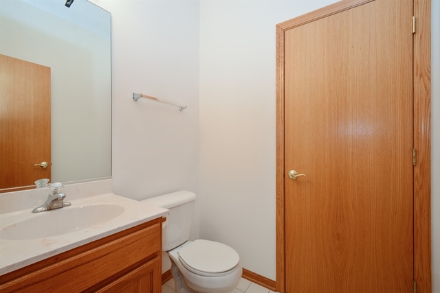 15652 Scotsglen Road Orland Park, IL 60462 - Photo 13 of 15 a bathroom with a sink a toilet and shower