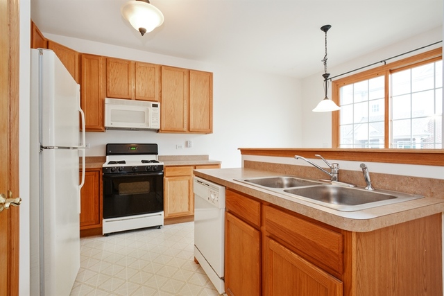15652 Scotsglen Road Orland Park, IL 60462 - Photo 4 of 15 a kitchen with stainless steel appliances granite countertop a sink stove and refrigerator