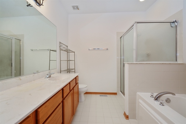 15652 Scotsglen Road Orland Park, IL 60462 - Photo 7 of 15 a bathroom with a sink and a mirror