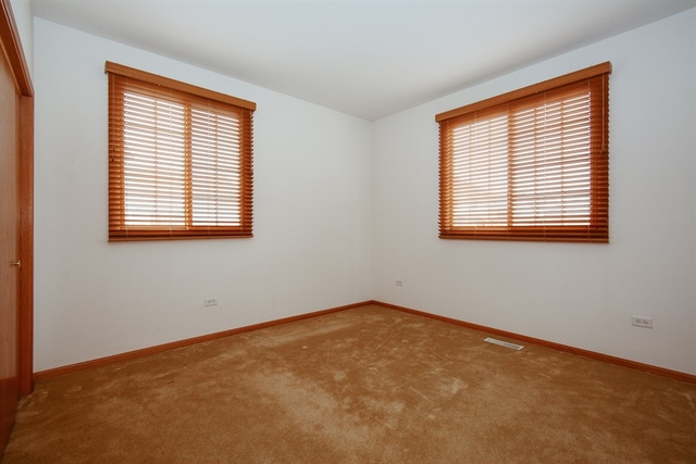 15652 Scotsglen Road Orland Park, IL 60462 - Photo 8 of 15 an empty room with a window