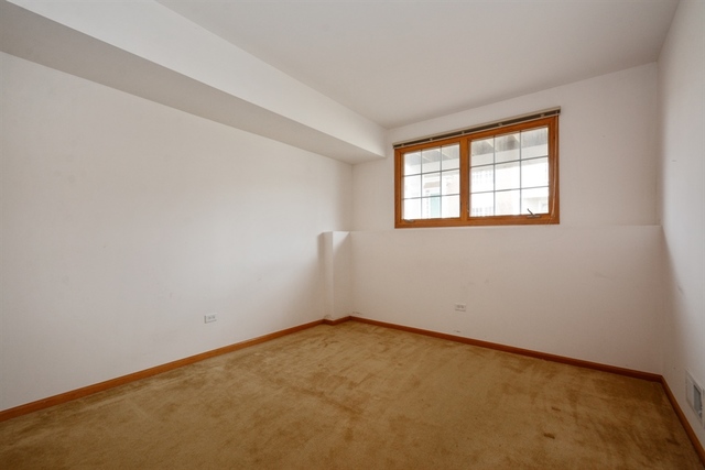 15652 Scotsglen Road Orland Park, IL 60462 - Photo 9 of 15 an empty room with a window