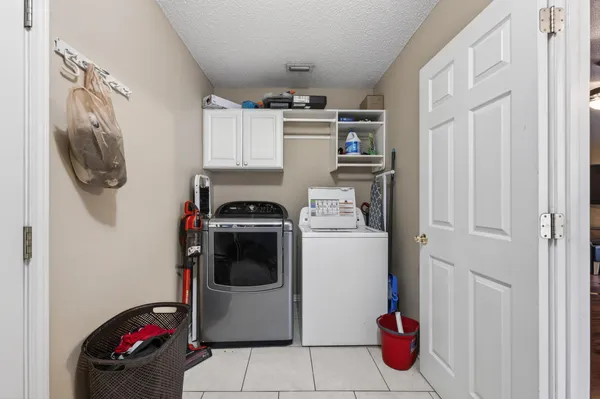 a utility room with sink dryer and washer