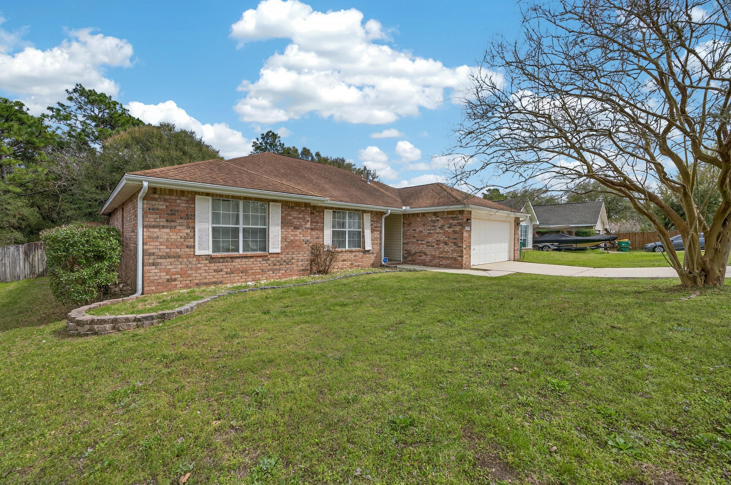 4717 Whitewater Lane Crestview, FL 32539 - Photo 2 of 55 a front view of a house with a garden