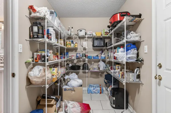 a bedroom with a bed and a flat tv screen on dresser