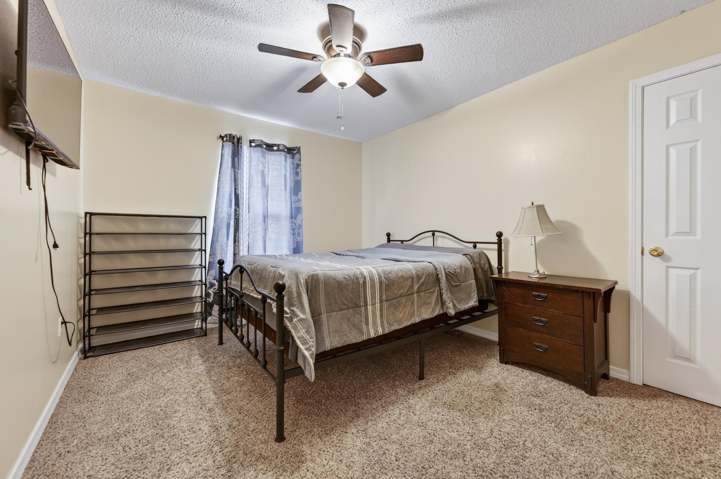 4717 Whitewater Lane Crestview, FL 32539 - Photo 24 of 55 a bedroom with a bed and a flat tv screen on dresser