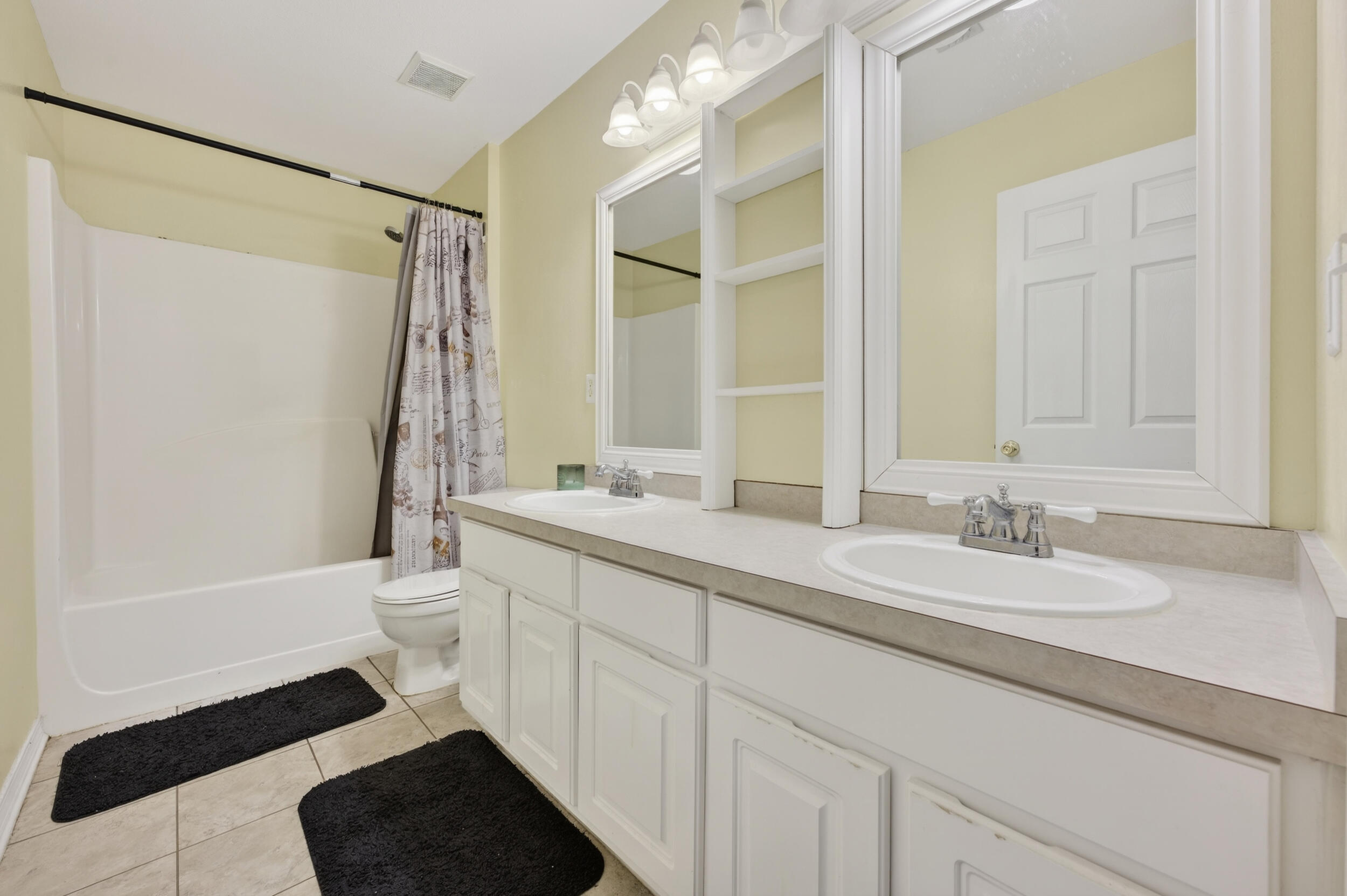 4717 Whitewater Lane Crestview, FL 32539 - Photo 26 of 55 a bathroom with a double vanity sink toilet mirror and shower