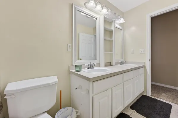 a bedroom with a bed and dresser with mirror