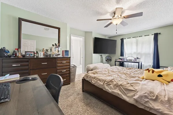 a bedroom with a bed and a chandelier