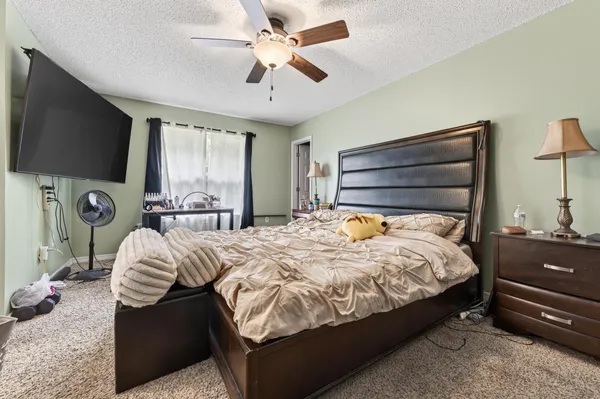 a bedroom with a bed and a flat screen tv