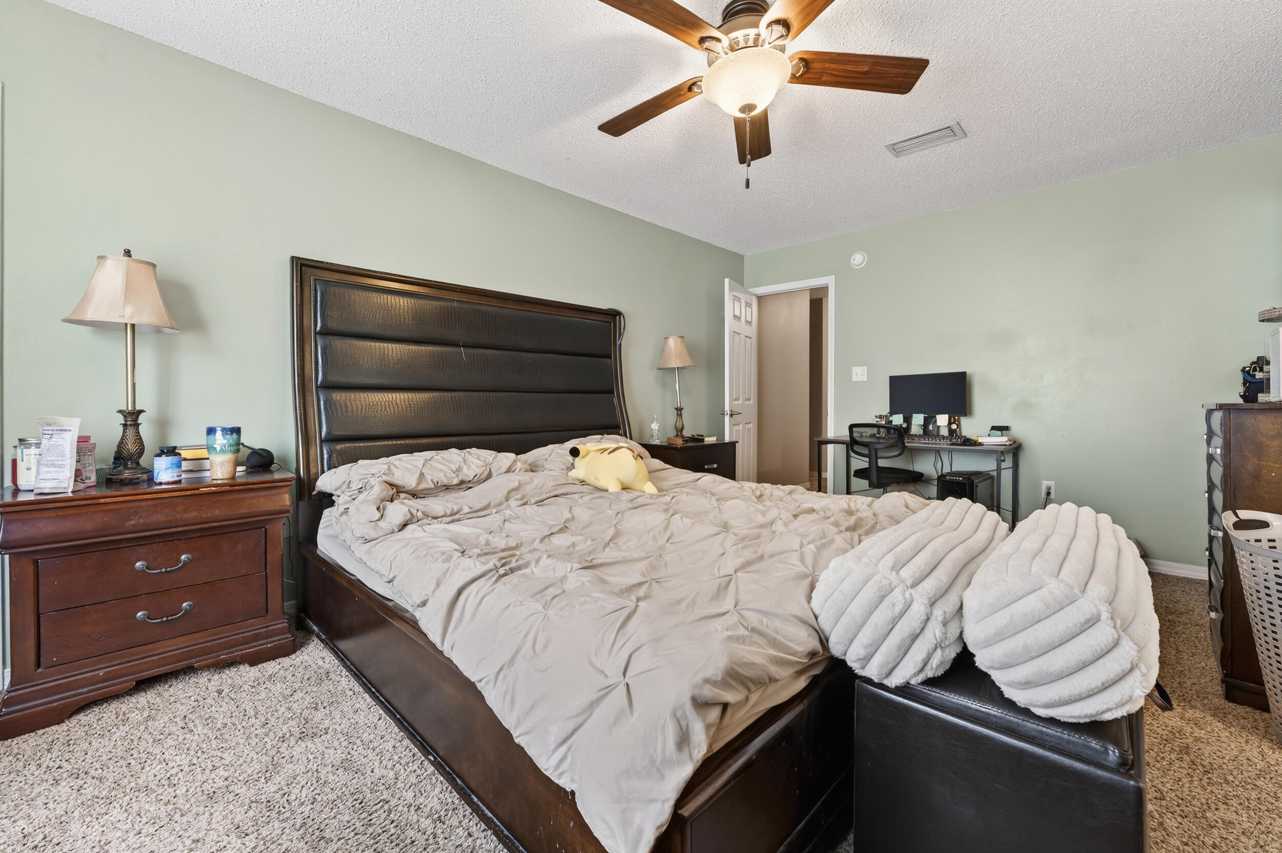 4717 Whitewater Lane Crestview, FL 32539 - Photo 31 of 55 a bedroom with a bed and a chandelier