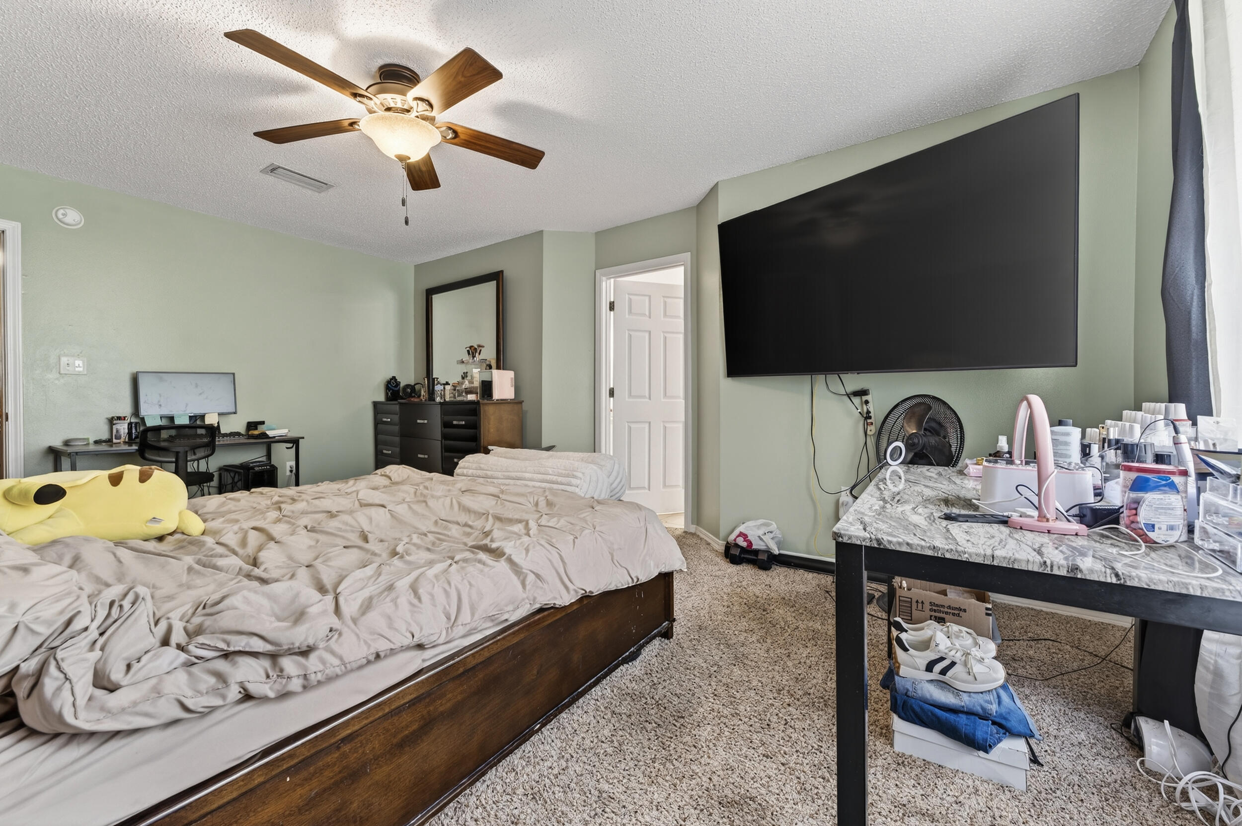 4717 Whitewater Lane Crestview, FL 32539 - Photo 32 of 55 a bedroom with a bed and a flat screen tv