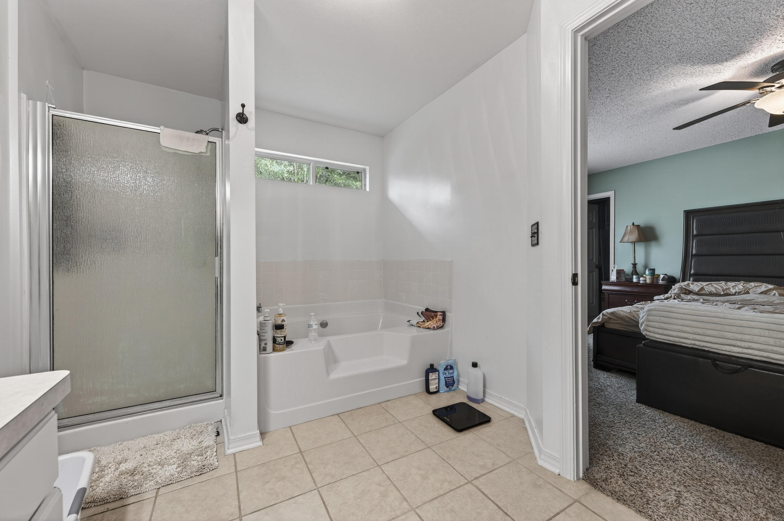 4717 Whitewater Lane Crestview, FL 32539 - Photo 36 of 55 a bathroom with a bathtub and a shower