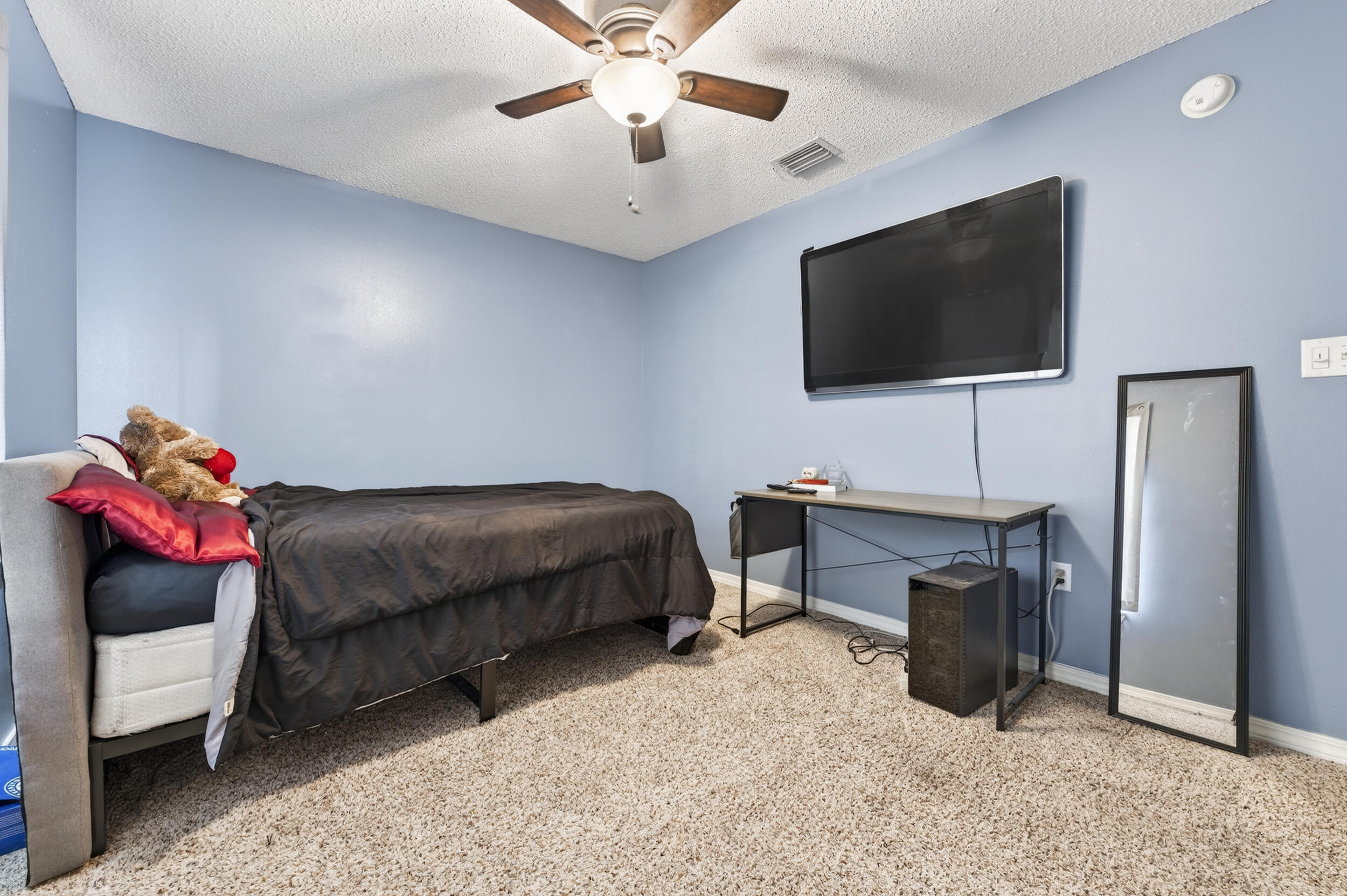 4717 Whitewater Lane Crestview, FL 32539 - Photo 41 of 55 a bedroom with a bed and flat screen tv